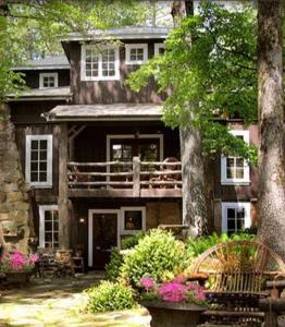 uma casa grande com uma varanda em frente em Lake Rabun Hotel em Lakemont