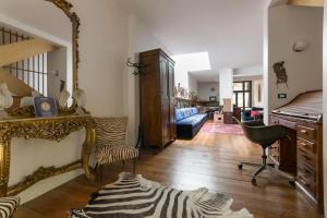 a living room with a staircase and a zebra rug at B&B AlbertaD in Bologna