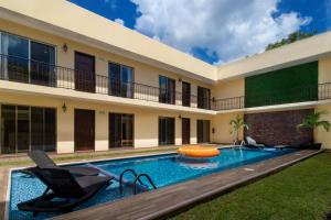 a swimming pool in the backyard of a house at PRIME VILLAGE Cozumel in Cozumel