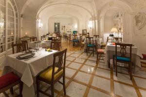 a restaurant with tables and chairs in a room at Mediterraneo Emotional Hotel & Spa in Santa Margherita Ligure
