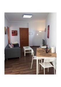 a living room with a couch and a table at Apartamentos cerca del Aeropuerto in Ingenio