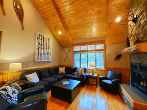 a living room with a couch and a fireplace at Big Pines Lodge in Sunriver