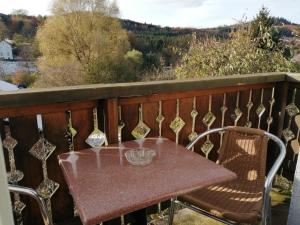 a table and chairs on a balcony with a view at Mamyvonne Vacances in Tendon