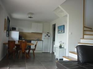 a kitchen and living room with a table and chairs at La Maison De La Rade in Le Relecq-Kerhuon