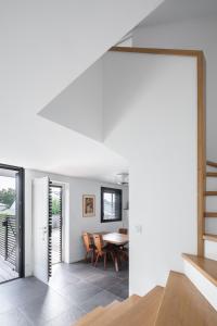 an open living room with a table and a staircase at La Maison De La Rade in Le Relecq-Kerhuon