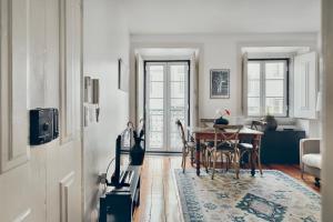 リスボンにあるCasa Dos Azulejos - Lapaのテーブルとダイニングルームのあるリビングルーム