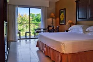 a bedroom with a large bed and a balcony at Occidental Papagayo ALL INCLUSIVE-Adults Only in Culebra