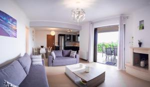 a living room with a blue couch and a fireplace at PANORAMA APARTMENT in Apolpaina