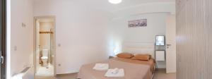 a bedroom with a bed with two towels on it at PANORAMA APARTMENT in Apolpaina