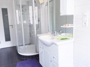a white bathroom with a sink and a shower at Bozen - Gries in Bolzano