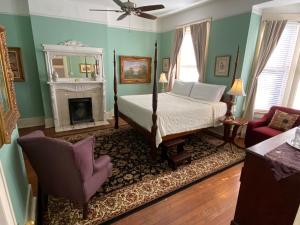 a living room filled with furniture and a fire place at Foley House Inn in Savannah