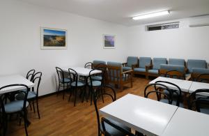 a room with tables and chairs in a classroom at Hotel Miramar - São Pedro de Moel in São Pedro de Moel