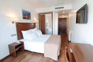 Postel nebo postele na pokoji v ubytování Hotel Miramar - São Pedro de Moel