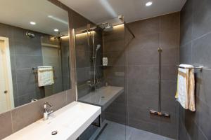 a bathroom with a sink and a shower at TamTam Studio in Rotterdam