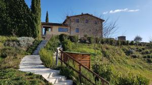 a house on a hill with stairs leading up to it at Chianti B&B Design infinity pool shared in Pianella