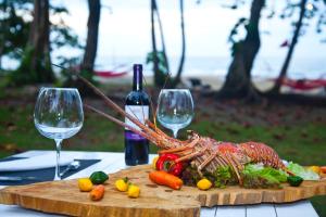a plate of meat and vegetables on a table at Le Cameleon Boutique Hotel in Puerto Viejo