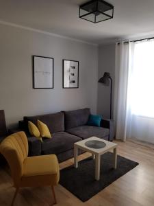 a living room with a couch and a coffee table at Apartament Grottgera in Kłodzko