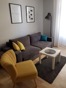 a living room with a couch and a coffee table at Apartament Grottgera in Kłodzko