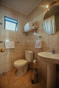 a bathroom with a toilet and a sink and a mirror at Cabañas Campanario in La Serena