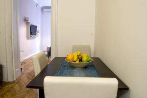 a table with a bowl of fruit on top of it at Lux Apartment in Belgrade 2 in Belgrade