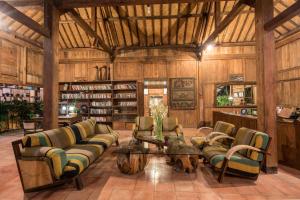 un soggiorno con divani e un tavolo di D'omah Yogya Hotel a Yogyakarta