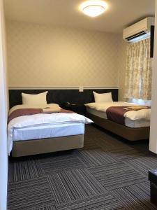 Postel nebo postele na pokoji v ubytování Hotel Sunmarine
