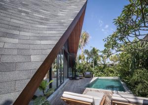 an external view of a house with a swimming pool at The River Studio in Canggu