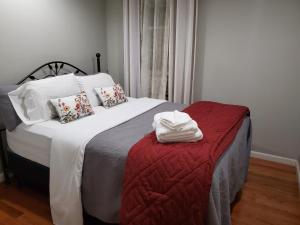 a bedroom with a large bed with a red blanket at Cozy Retreat on Atlantic Ave in Brooklyn
