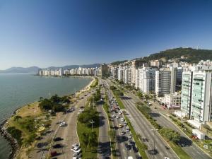 an aerial view of a city with buildings and the ocean at Residencial Ponta Norte -Ponta das Canas in Florianópolis