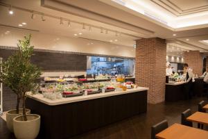 a restaurant with a counter with plants on it at La Vista Furano Hills Natural Hot Spring in Furano