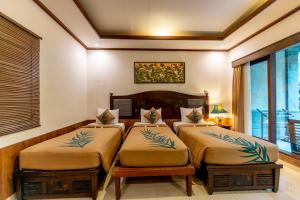 Postel nebo postele na pokoji v ubytování De Munut Balinese Resort