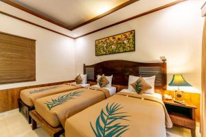 Postel nebo postele na pokoji v ubytování De Munut Balinese Resort