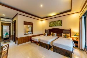 Postel nebo postele na pokoji v ubytování De Munut Balinese Resort