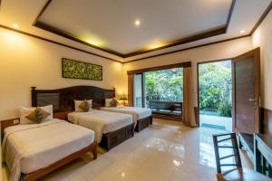 Postel nebo postele na pokoji v ubytování De Munut Balinese Resort + 37 fotografií