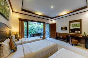 Postel nebo postele na pokoji v ubytování De Munut Balinese Resort