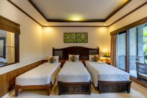 Postel nebo postele na pokoji v ubytování De Munut Balinese Resort