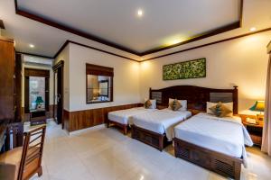 Postel nebo postele na pokoji v ubytování De Munut Balinese Resort
