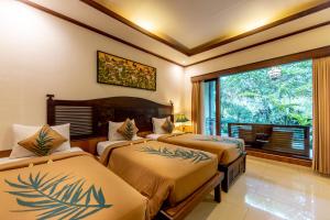 Postel nebo postele na pokoji v ubytování De Munut Balinese Resort