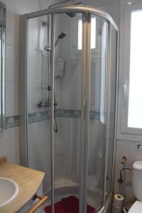 a shower with a glass door in a bathroom at Hipster Studio in Anton Martin by Allô Housing in Madrid