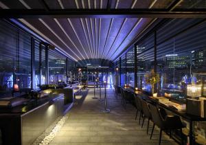 a restaurant with a view of a city at night at Nine Tree Premier Hotel Insadong Myeongdong in Seoul