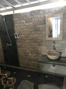 a bathroom with a sink and a shower at Cliff Park Lembongan in Nusa Lembongan
