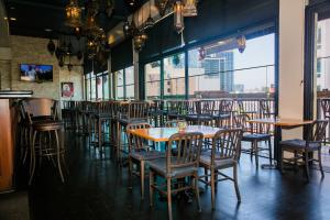 a row of tables and chairs in a restaurant at Porto Vista Hotel In Little Italy in San Diego