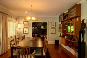 a dining room with a wooden table and chairs at Hawthorne House in Hastings