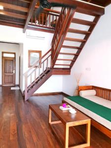 a room with a bed and a staircase at Cardamon Hotel Nilaveli in Nilaveli