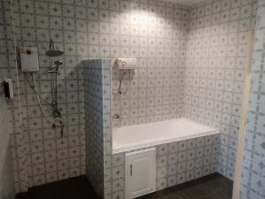 a bathroom with a shower and a white sink at NONKAJA HOSTEL in Pak Chong
