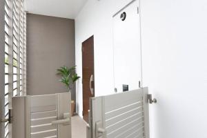 two white doors in a hallway with a plant at Ocean Resort 101 in Shioya +35 photos