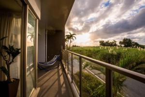 a balcony with a chair and a view of a field at Ocean Resort 101 in Shioya