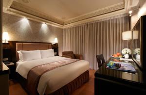 Postel nebo postele na pokoji v ubytování Deja Vu Hotel