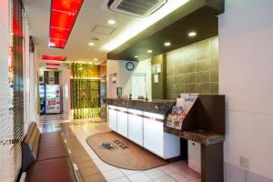 a large kitchen with a counter in a restaurant at Sejour Inn Nagarekawa in Hiroshima