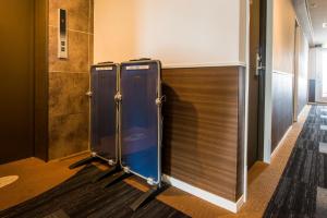 a couple of blue stalls in a hallway at Sejour Inn Nagarekawa in Hiroshima
